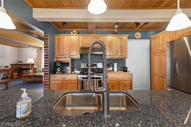 kitchen with beamed ceiling, dark stone counters, pendant lighting, wood ceiling, and appliances with stainless steel finishes