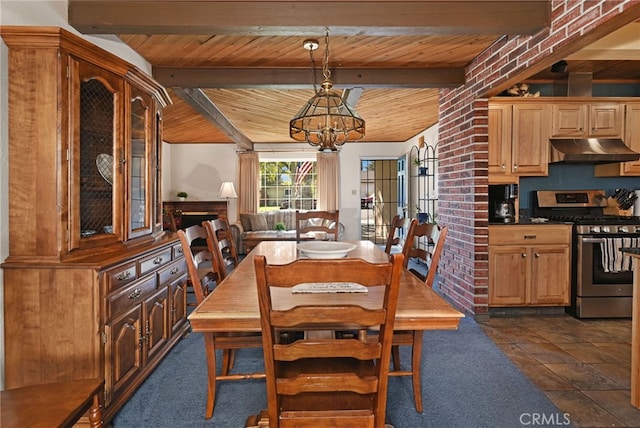 dining space with vaulted ceiling with beams, dark tile patterned floors, wooden ceiling, and an inviting chandelier