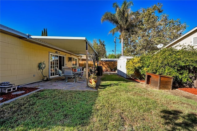 view of yard featuring a patio area and a storage unit