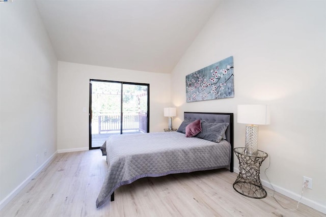 bedroom featuring vaulted ceiling, access to exterior, and light hardwood / wood-style flooring