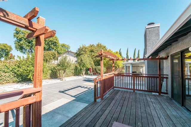 wooden terrace with a pergola and a patio