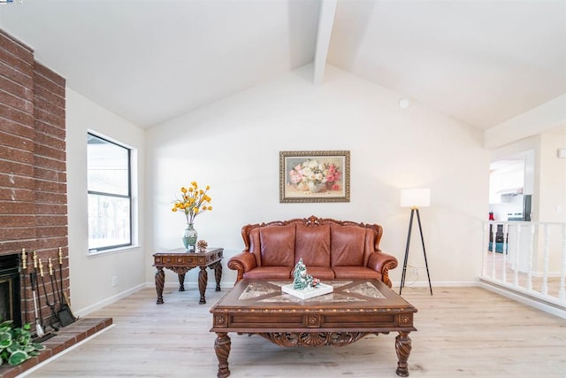 living room with vaulted ceiling with beams, light wood-type flooring, and a fireplace