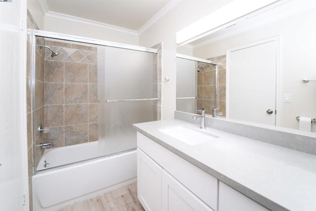 bathroom with vanity, wood-type flooring, shower / bath combination with glass door, and crown molding