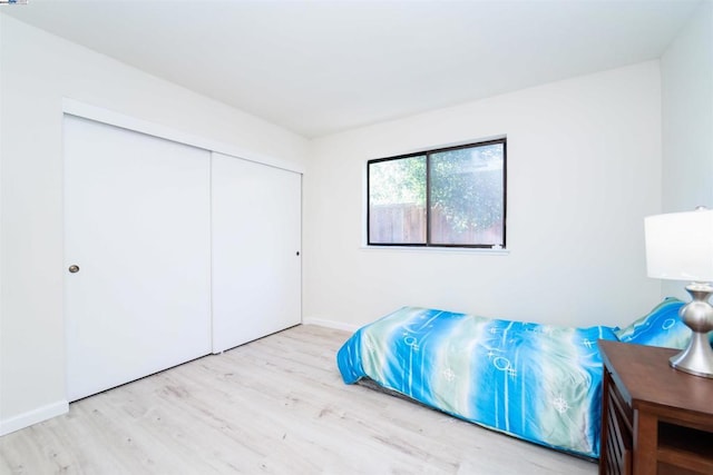 bedroom featuring a closet and light hardwood / wood-style floors