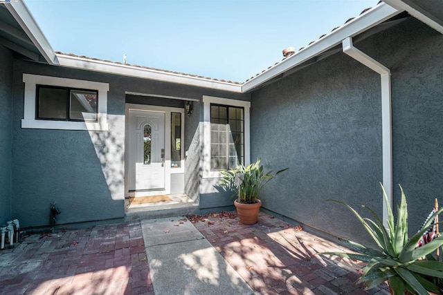 entrance to property with a patio