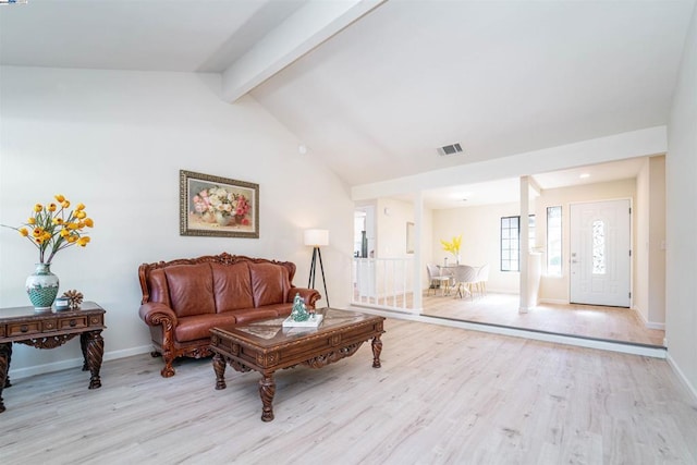 living room with vaulted ceiling with beams and light hardwood / wood-style flooring