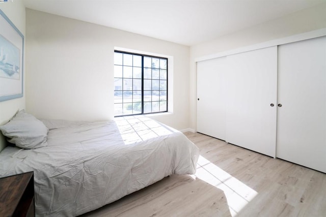 bedroom featuring a closet and light hardwood / wood-style flooring