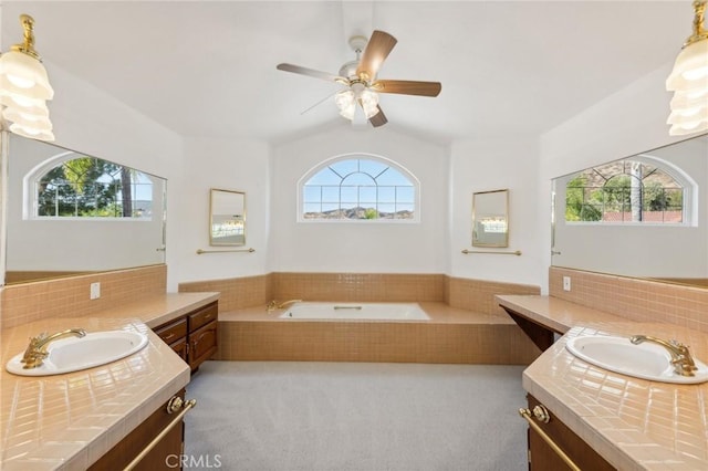 bathroom with plenty of natural light, ceiling fan, lofted ceiling, and vanity