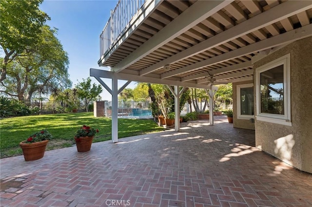 view of patio featuring a balcony and ceiling fan