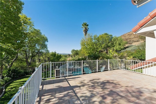 view of patio featuring a balcony