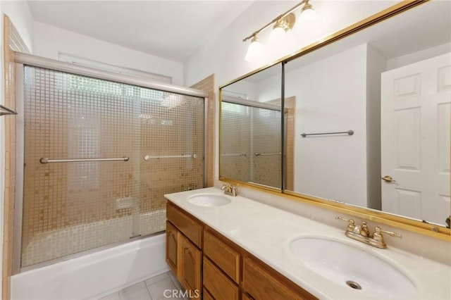 bathroom with tile patterned floors, vanity, and combined bath / shower with glass door