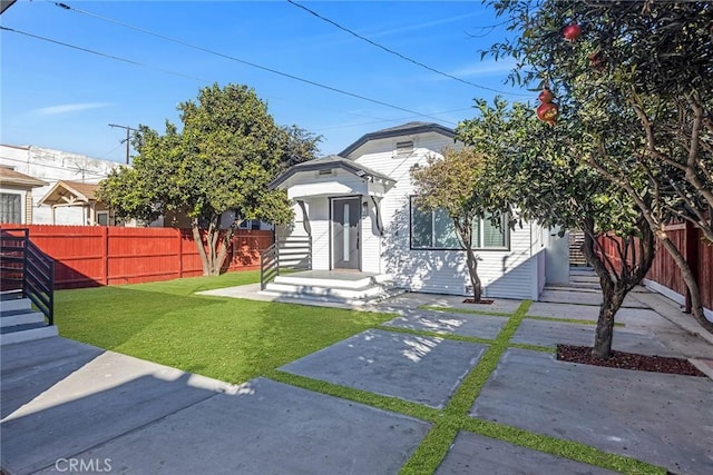 bungalow-style home featuring a front yard