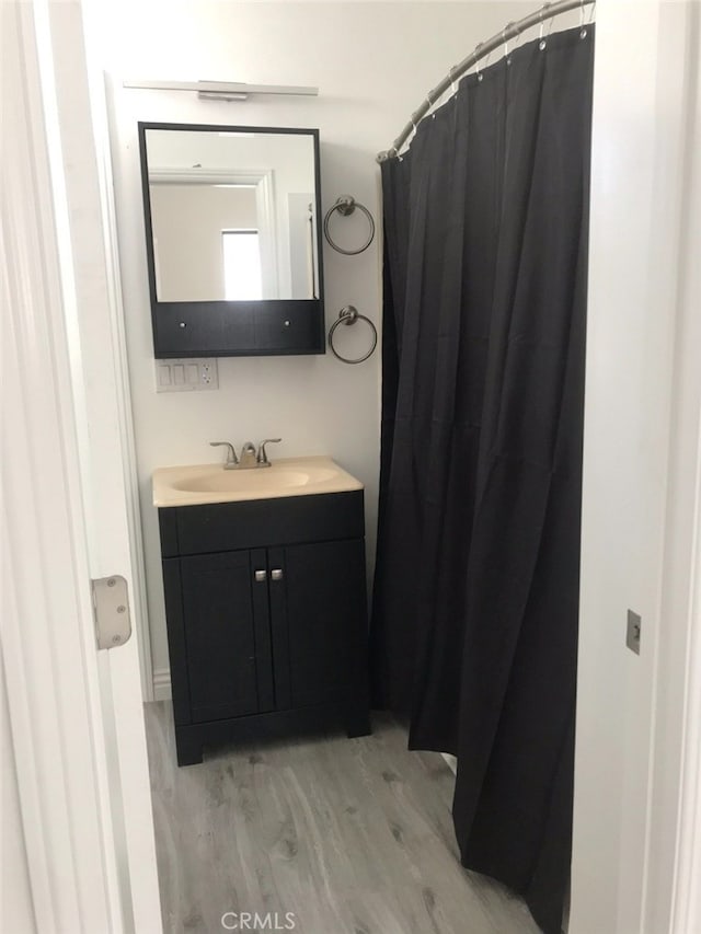 bathroom with vanity and wood-type flooring