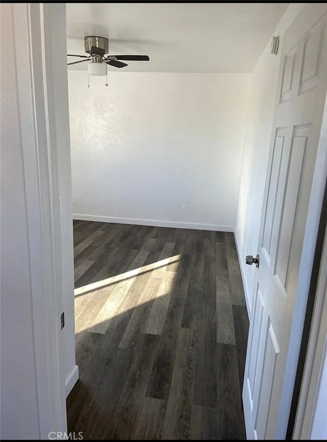 spare room featuring ceiling fan and dark hardwood / wood-style flooring