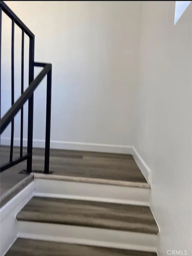 stairway featuring hardwood / wood-style flooring