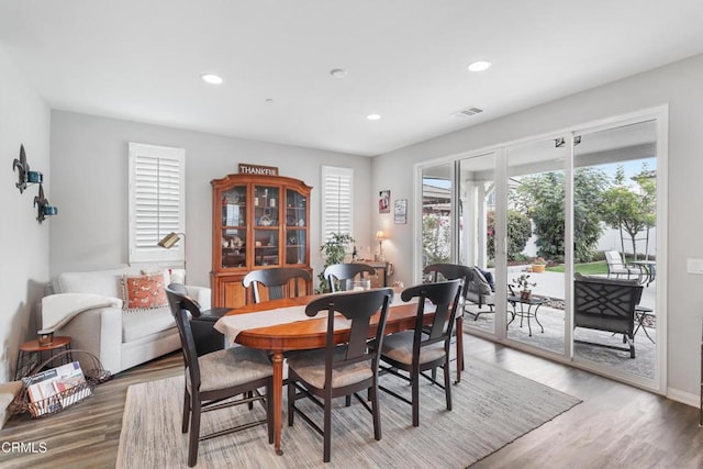 dining room with a wealth of natural light and hardwood / wood-style floors