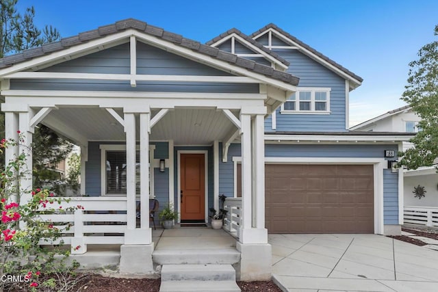 craftsman-style house featuring covered porch and a garage