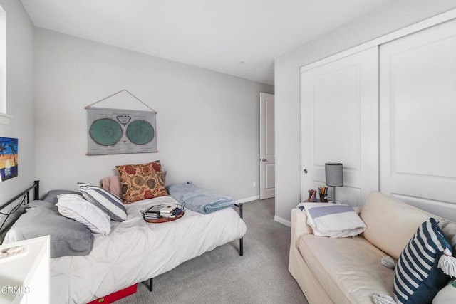 bedroom with carpet and a closet