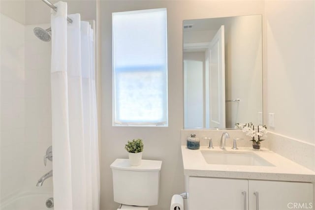 full bathroom featuring toilet, vanity, and shower / tub combo with curtain