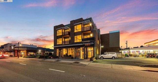 view of outdoor building at dusk