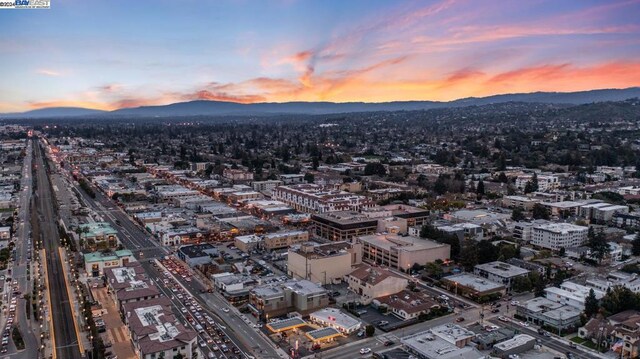 aerial view at dusk featuring a mountain view