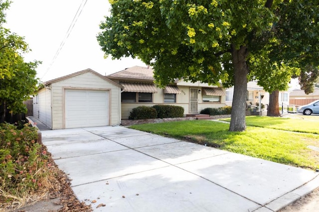 single story home featuring a garage and a front lawn