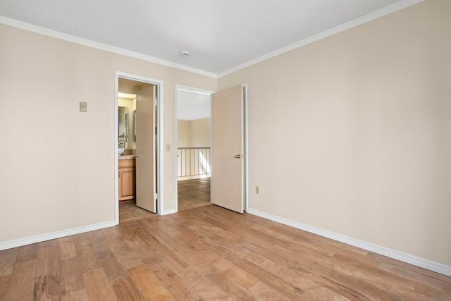 spare room with light hardwood / wood-style flooring and crown molding