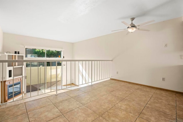 tiled empty room with ceiling fan