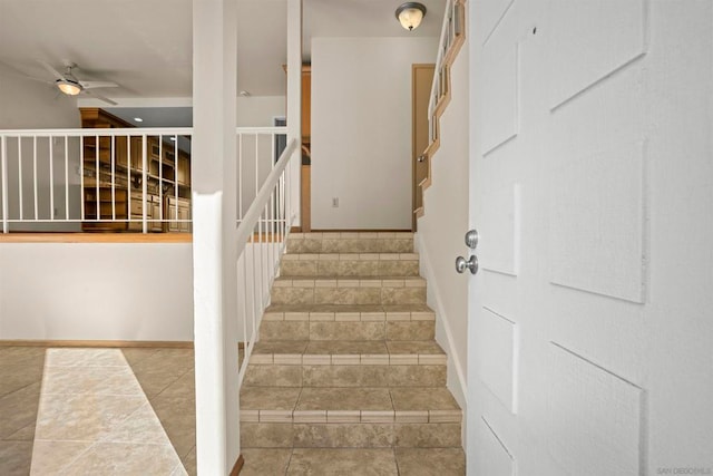 stairs with tile patterned flooring and ceiling fan