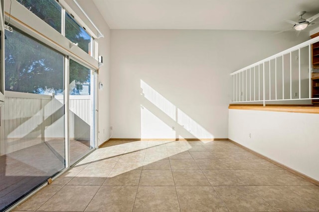 tiled empty room featuring ceiling fan