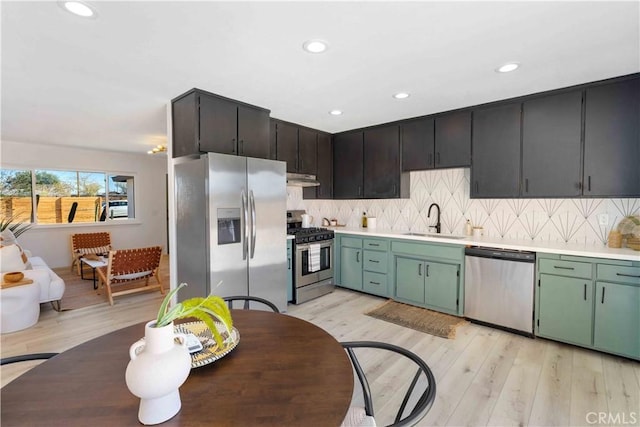 62044 Valley View Cir, Joshua Tree, CA 92252 - kitchen with appliances with stainless steel finishes, light countertops, decorative backsplash, light wood-style floors, and recessed lighting