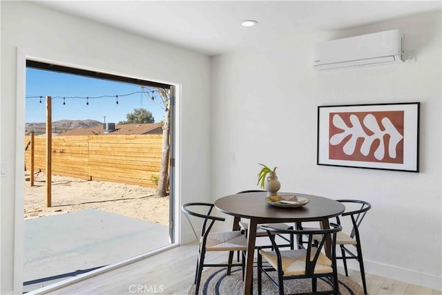 62044 Valley View Cir, Joshua Tree, CA 92252 - dining space with a wall unit AC, wood finished floors, and recessed lighting
