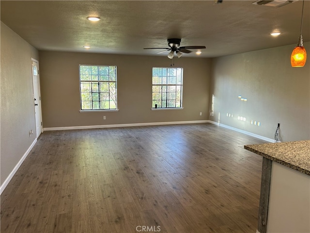 interior space with dark hardwood / wood-style floors and ceiling fan