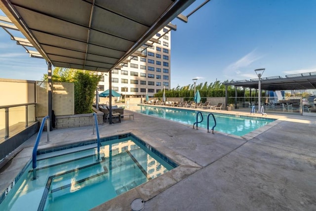 view of pool featuring a patio area and a hot tub