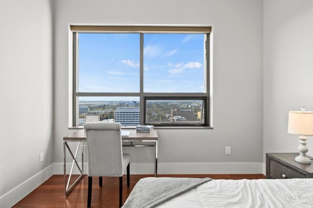 bedroom with dark wood-type flooring and multiple windows