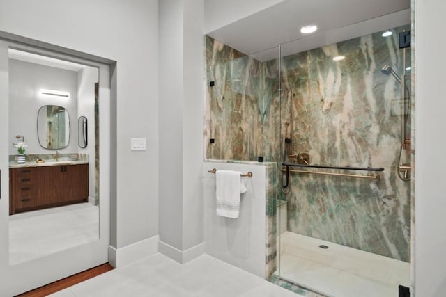 bathroom featuring vanity, wood-type flooring, and an enclosed shower