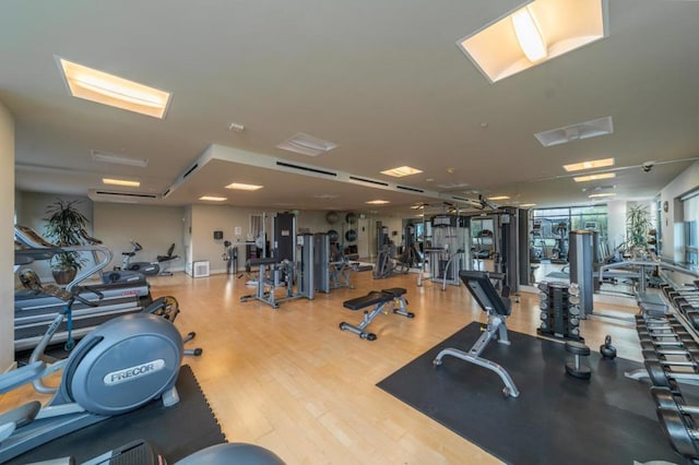 exercise room with wood-type flooring