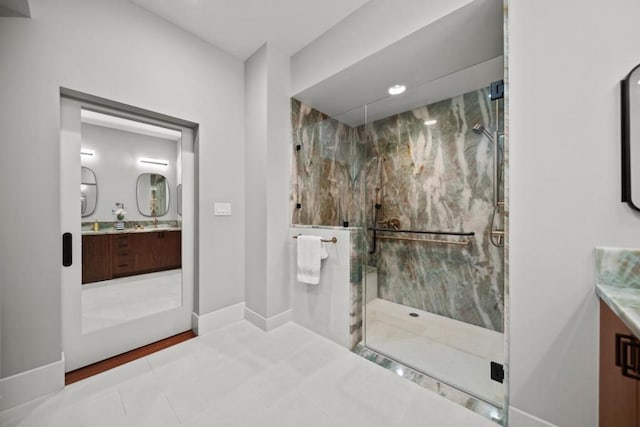 bathroom with tile patterned flooring, vanity, and a shower with shower door