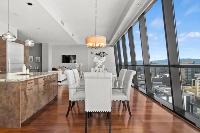 dining room featuring dark hardwood / wood-style floors and an inviting chandelier