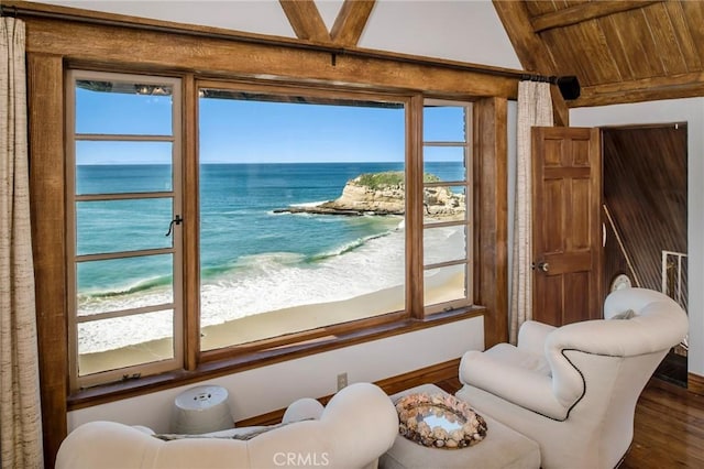 doorway featuring a beach view, a water view, and hardwood / wood-style floors