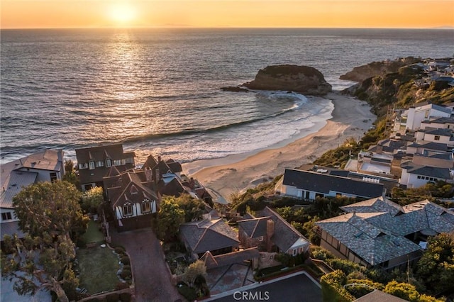 aerial view at dusk with a residential view and a water view