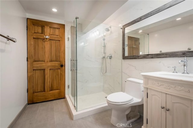 bathroom with toilet, recessed lighting, a marble finish shower, tile patterned flooring, and vanity