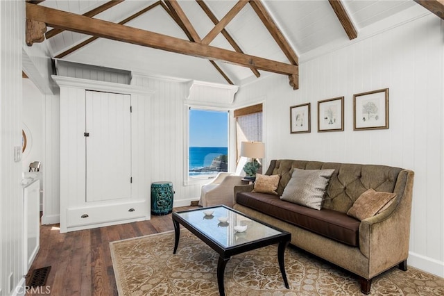 living area featuring visible vents, lofted ceiling with beams, baseboards, and wood finished floors