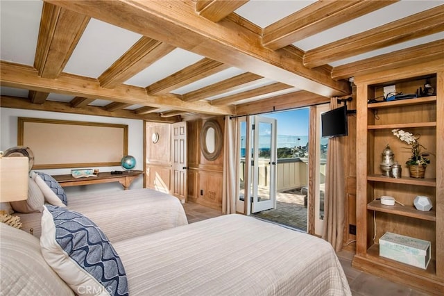 bedroom with access to exterior, coffered ceiling, and beam ceiling