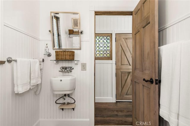 bathroom featuring wood finished floors and wainscoting