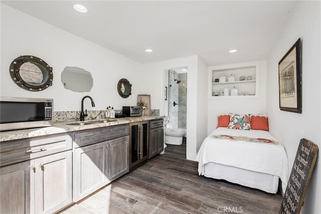 bedroom with a sink, recessed lighting, ensuite bath, and dark wood-style flooring