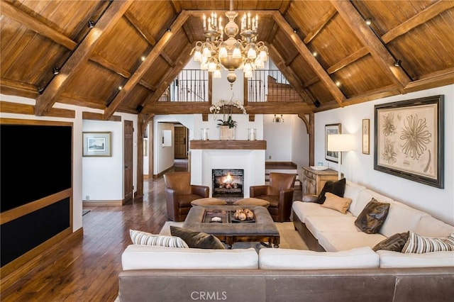 living room with hardwood / wood-style floors, wooden ceiling, a warm lit fireplace, and an inviting chandelier