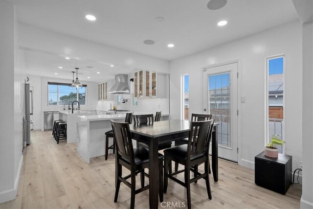 dining space featuring light hardwood / wood-style flooring and sink