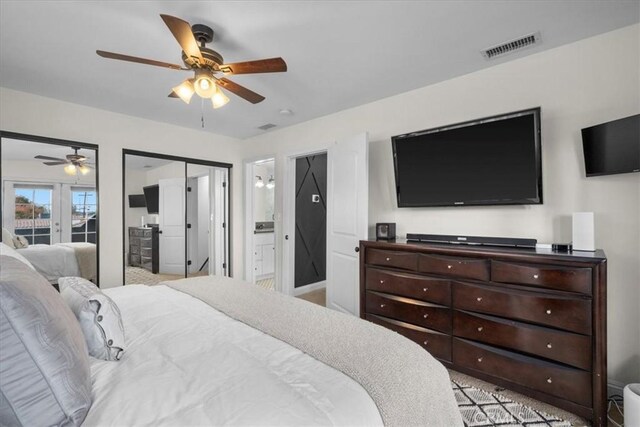 bedroom with connected bathroom, ceiling fan, french doors, and light carpet