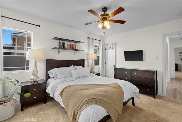 carpeted bedroom with ceiling fan